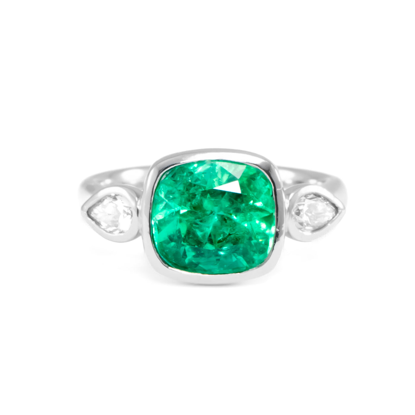 Three stone cushion emerald and diamond in platinum ring