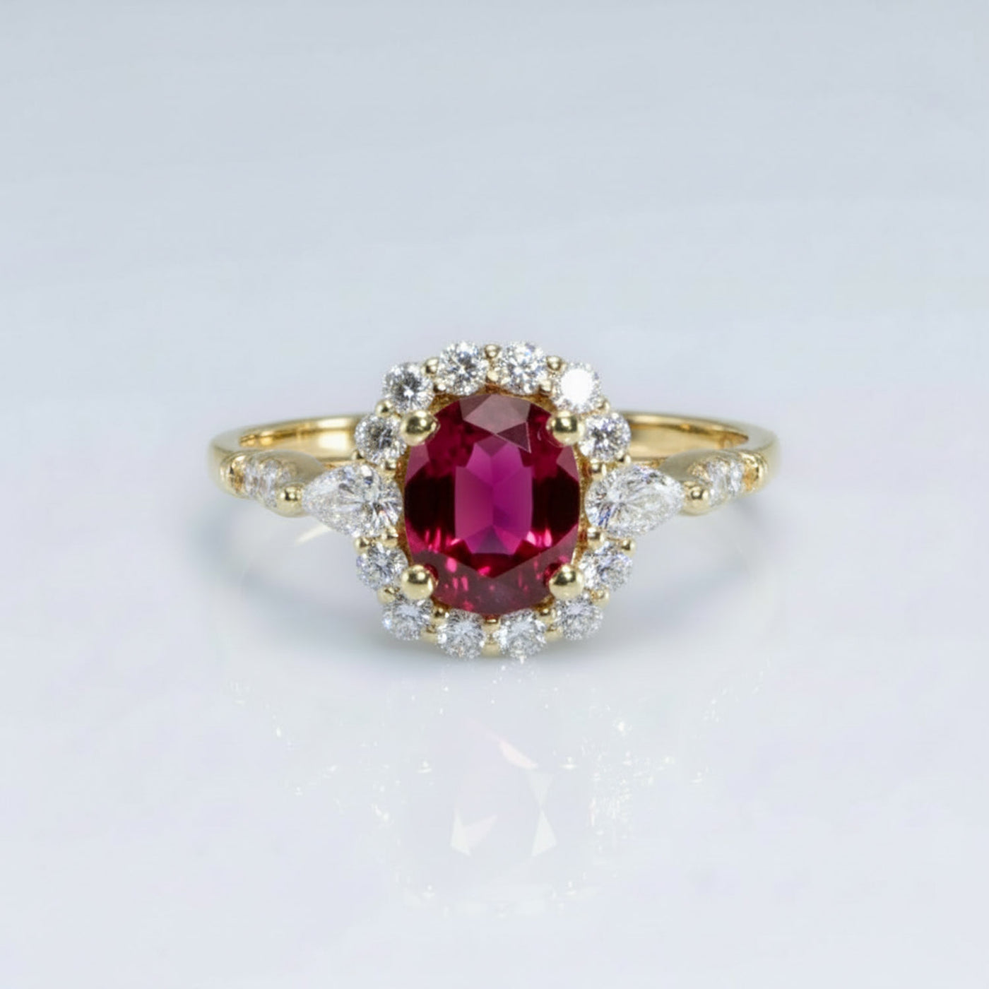 Cushion Cut Ruby Halo Engagement Ring with Pear Diamond Sides in 18K Yellow Gold"